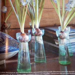 Glass vases with blue flowers